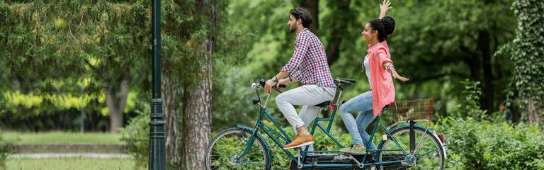 couple riding a tandem bike