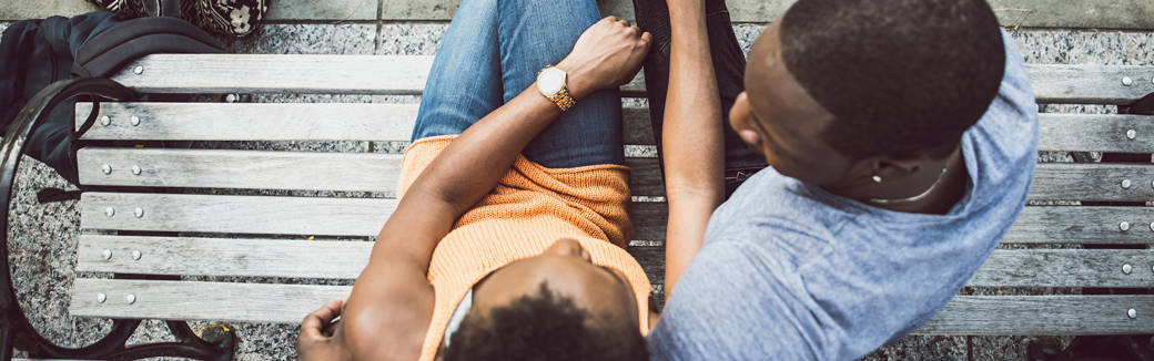 husband & wife sitting together on a bench