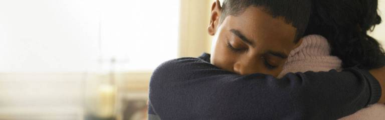 Black mother comforting her son